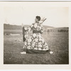 Jerome Robbins dancing outdoors in robe with fan