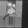 Two men looking out of train window