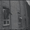 Children in the windows of an abandoned building