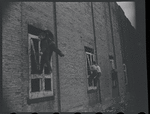 Children in the windows of an abandoned building