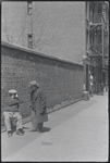 Two men conversing on the street. New York, NY