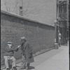 Two men conversing on the street. New York, NY