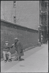 Two men conversing on the street. New York, NY