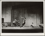 Female dancer stage right with hand out to stop male dancer stage left
