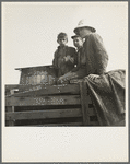 On location of Resettlement Administration film near Bakersfield, California. Three brothers, drought refugees from Texas (note water barrel)