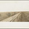 Typical view of the rolling character of the area. Town of Mills in distance, New Mexico