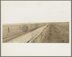 Typical view of the rolling character of the area. Town of Mills in distance, New Mexico