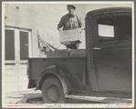 Loading milk at the self-help cooperative dairy which is being taken over by the Resettlement Administration. Near Santa Ana, California