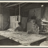 Grandmother from Oklahoma with grandson, working on quilt. California, Kern County