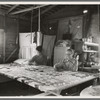 Grandmother from Oklahoma with grandson, working on quilt. California, Kern County
