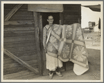 Grandmother from Oklahoma and her pieced quilt. California, Kern County