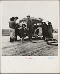 Migrants, family of Mexicans, on road with tire trouble. Looking for work in the peas. California