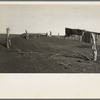 Fence corner and outbuilding being buried by dust. Misuse of lands is the chief cause of results such as this. Mills, New Mexico