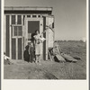 Resettled at Bosque Farms project. Family of four from Taos Junction shows temporary dwelling