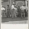 Drought farmers line the shady side of the main street on the town while their crops burn up in the fields. "Hello Bill, when's it gonna rain?" [Sallisaw, Okl.]