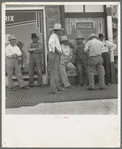 Drought farmers line the shady side of the main street on the town while their crops burn up in the fields. "Hello Bill, when's it gonna rain?" [Sallisaw, Okl.]