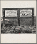 Employment signs in Spanish and English. These ranches (1938) increasingly use Negro pickers. Near Fresno, California