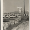 Outskirts of San Bernardino, California. Cottage Gardens road sign. This sign advertises a depression community. There are one hundred homes. All but fifteen of the families were living on SSRA work and buying their homes on this budget ...