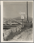 Outskirts of San Bernardino, California. Cottage Gardens road sign. This sign advertises a depression community. There are one hundred homes. All but fifteen of the families were living on SSRA work and buying their homes on this budget ...