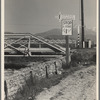 Outskirts of San Bernardino, California. Cottage Gardens road sign. This sign advertises a depression community. There are one hundred homes. All but fifteen of the families were living on SSRA work and buying their homes on this budget ...