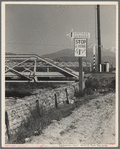 Outskirts of San Bernardino, California. Cottage Gardens road sign. This sign advertises a depression community. There are one hundred homes. All but fifteen of the families were living on SSRA work and buying their homes on this budget ...