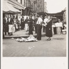 Background photo for Hightstown project. Sixth Street and Avenue C, New York City, where the Solomon family do their shopping. In the street and displayed on newspaper. All socks for sale at ten cents the pair