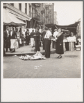 Background photo for Hightstown project. Sixth Street and Avenue C, New York City, where the Solomon family do their shopping. In the street and displayed on newspaper. All socks for sale at ten cents the pair