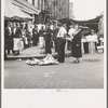 Background photo for Hightstown project. Sixth Street and Avenue C, New York City, where the Solomon family do their shopping. In the street and displayed on newspaper. All socks for sale at ten cents the pair