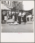 Background photo for Hightstown project. Sixth Street and Avenue C, New York City, where the Solomon family do their shopping. In the street and displayed on newspaper. All socks for sale at ten cents the pair