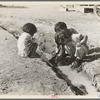 Mexican children playing in ditch which runs through company cotton camp near Corcoran, California