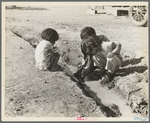 Mexican children playing in ditch which runs through company cotton camp near Corcoran, California