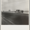 Migrant family on U.S. Highway 99 between Bakersfield and Famoso, California. Note: the photographer passed twenty-eight cars of this type while driving thirty-five miles between 9:00 and 9:45 in the morning