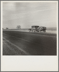 Migrant family on U.S. Highway 99 between Bakersfield and Famoso, California. Note: the photographer passed twenty-eight cars of this type while driving thirty-five miles between 9:00 and 9:45 in the morning