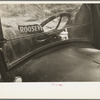 The windshield of a migratory agricultural laborer's car, in a squatter camp near Sacramento, California