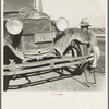 Migrant worker from Oklahoma repairing tire on California highway