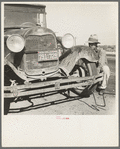 Migrant worker from Oklahoma repairing tire on California highway