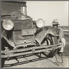 Migrant worker from Oklahoma repairing tire on California highway