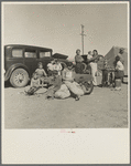 Four families, three of them related with fifteen children, from the Dust Bowl in Texas in an overnight roadside camp near Calipatria, California