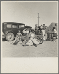 Four families, three of them related with fifteen children, from the Dust Bowl in Texas in an overnight roadside camp near Calipatria, California