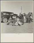 Four families, three of them related with fifteen children, from the Dust Bowl in Texas in an overnight roadside camp near Calipatria, California