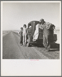 Oklahoma sharecropper and family entering California. Stalled on the desert near Indio, California