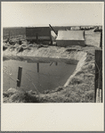 Ditch bank camp for migrant agricultural workers. California