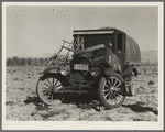 Texan refugees' car. They are seeking work in the carrot fields of the Coachella Valley. California