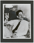 George S. Kaufman smoking, blowing smoke