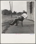 The sheriff of McAlester, Oklahoma, sitting in front of the jail. He has been sheriff for thirty years