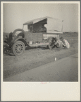 Family between Dallas and Austin, Texas. The people have left their home and connections in South Texas, and hope to reach the Arkansas Delta for work in the cotton fields. Penniless people. No food and three gallons of gas in the tank ...