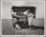 Family between Dallas and Austin, Texas. The people have left their home and connections in South Texas, and hope to reach the Arkansas Delta for work in the cotton fields. Penniless people. No food and three gallons of gas in the tank ...