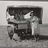 Family between Dallas and Austin, Texas. The people have left their home and connections in South Texas, and hope to reach the Arkansas Delta for work in the cotton fields. Penniless people. No food and three gallons of gas in the tank ...
