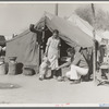 Tom Collins, manager of Kern migrant camp, with drought refugee family. California