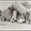 Tom Collins, manager of Kern migrant camp, with drought refugee family. California